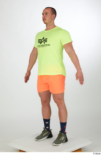 Joel a-pose dressed green sneakers orange shorts sports standing whole…